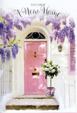 A peaceful new-home doorway in Noak Hill is captured here with a quiet elegance that feels both rural and refined. At the centre is a softly painted pink door, its hue gentle and reassuring, set against whitewashed walls that bounce soft, natural light back into the scene. A coordinating shutter, brushed in a paler blush, stands beside it, giving balance and reinforcing the calm, pastel palette. Above, thickly blooming wisteria pours down from an unseen trellis, its dangling clusters of lavender and lilac flowers forming a dreamy archway. Each tumbling strand of blossom varies in shade, from deeper purple at the stems to almost silvery at the tips, creating a layered canopy that looks as if it could sway in the breeze drifting across Noak Hill's open fields. Beneath this floral curtain, the stone step holds a grey metal bucket arranged by an experienced florist, overflowing with creamy white roses. Their petals are plush and rounded, layered in soft spirals that invite the imagination to touch, while sprigs of fresh green foliage weave through, adding lightness and life. A pink ribbon embraces the bucket and ties into a relaxed bow, its trailing ends curling naturally over the step, softly mirroring the pink of the door and unifying the composition. The entire scene suggests a thoughtful housewarming gesture delivered locally-a floral welcome to someone settling into a new address near Central Park or the winding roads of RM3. It radiates gentle optimism, as if every rose and wisteria blossom is quietly blessing the threshold with warmth, good fortune, and the promise that this house will quickly become a true home.